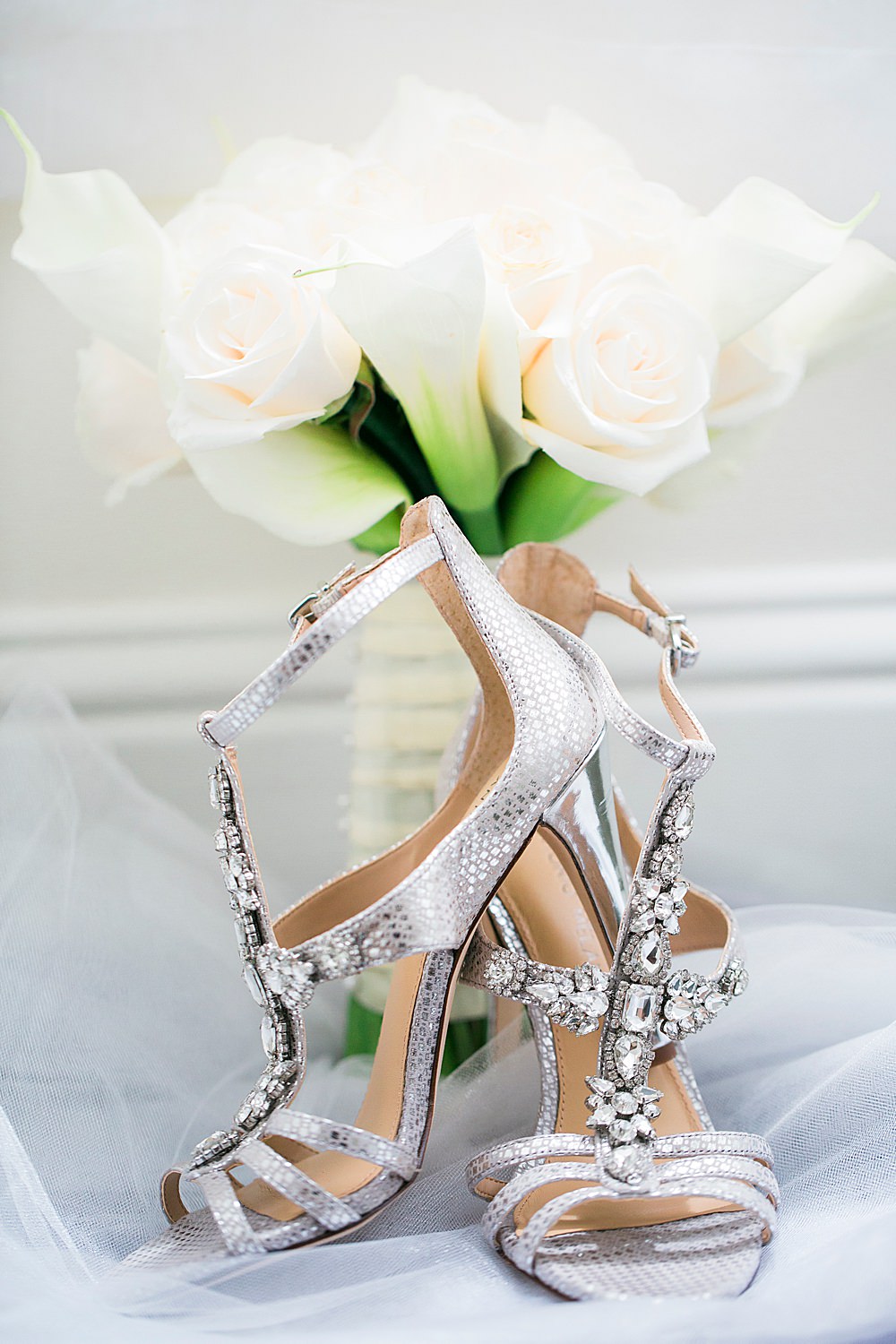 Detail photo of silver jewled heels with white rose bouquet