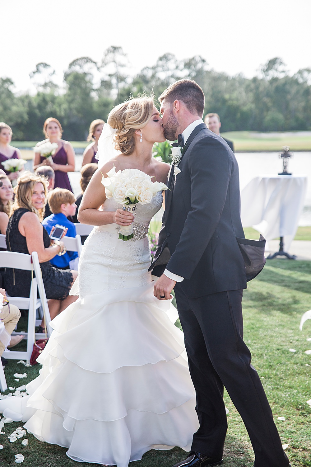 Bride and groom share first kiss at their wedding ceremony