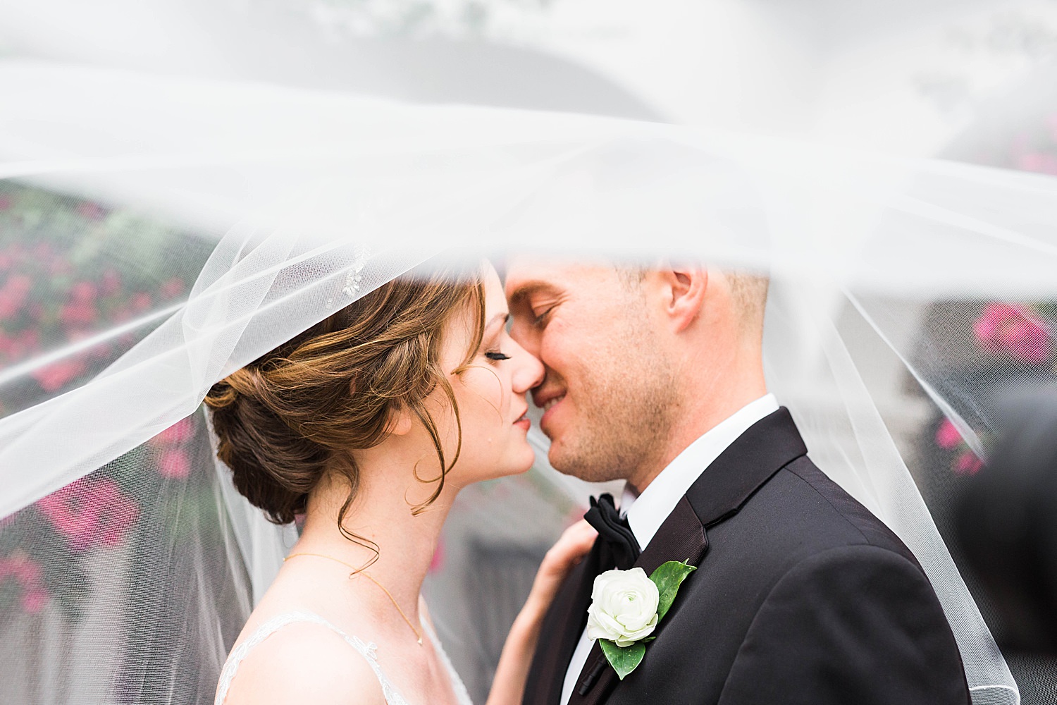 Bride and Groom share intimate moment before kiss underneath a veil at the treasury st augustine